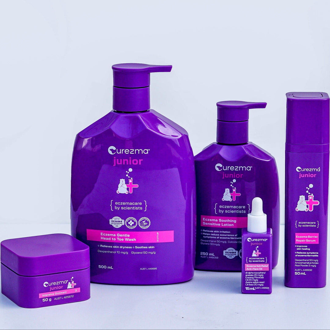 Purple Curezma children's skincare product set on a light gray background