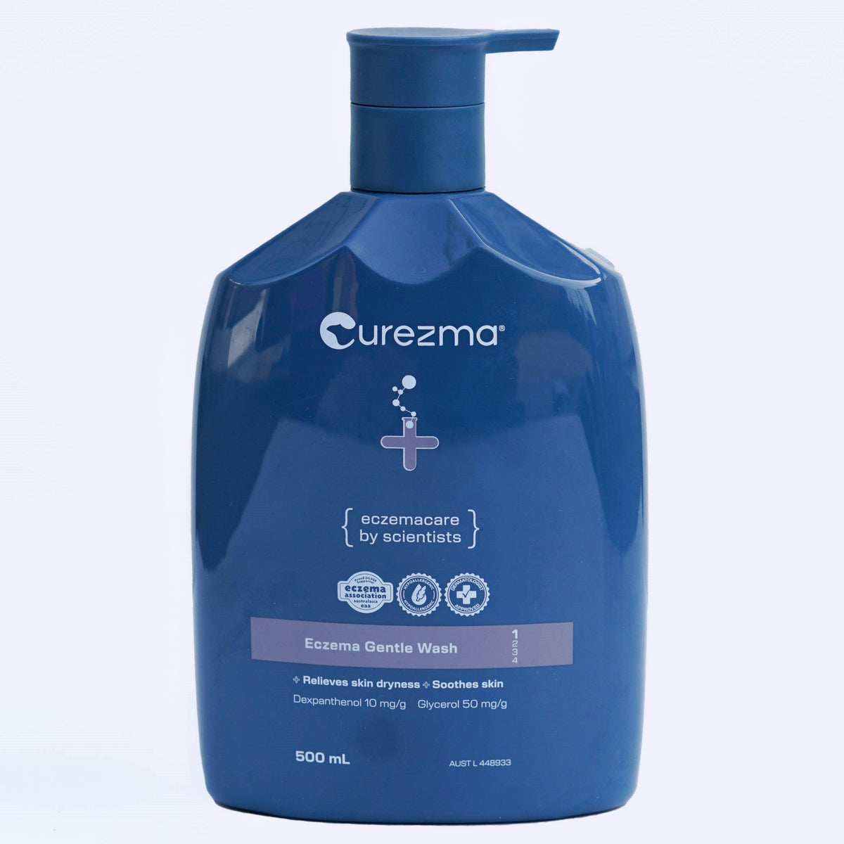 Blue bottle of Curezma Eczema Gentle Wash on a light purple background