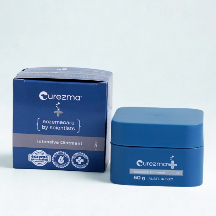 Curezma Intensive Ointment jar and packaging on a light blue background