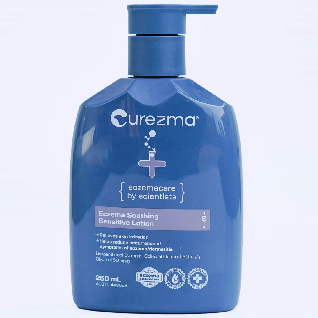 Blue bottle of Curezma Eczema Soothing Sensitive Lotion on a light purple background