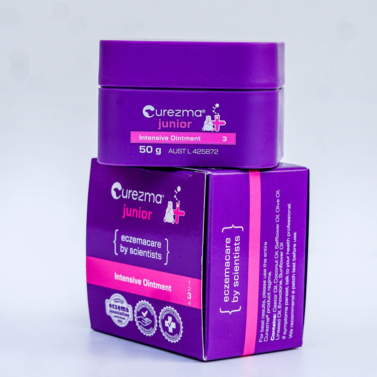 Purple jar and box of Curezma Junior Intensive Ointment on a light gray background